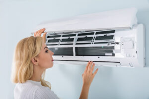 A woman looking at her wall AC system in El Paso.