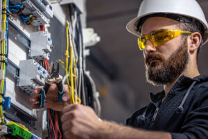 A person performing electrical work on an El Paso home.